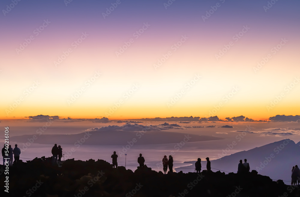 Mountaintop sunset overlooking Hawaiian islands.