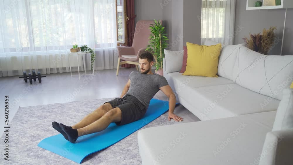 Mid adult fitness man exercising at home.
Man exercises, burns fat, burns calories, strength training, home fitness.
