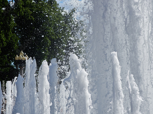 Fototapeta Naklejka Na Ścianę i Meble -  Fountain of water against the background of blue sky and white clouds