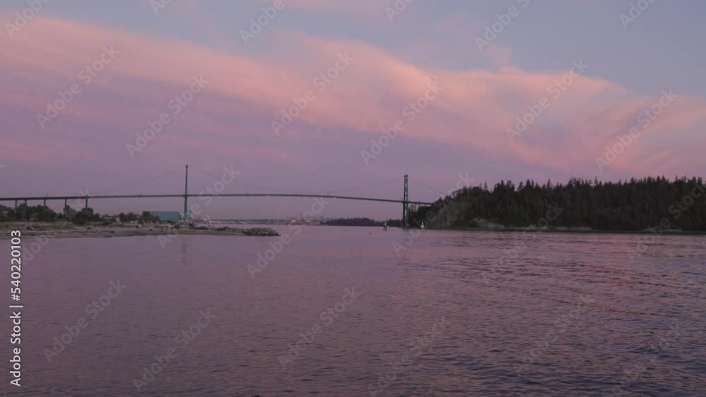 Lions Gate Bridge in Vancouver's harbor next to Stanley Park at sunset. 4K 24FPS. Lions Gate Bridge in Vancouver's harbor next to Stanley Park at sunset. 4K 24FPS.