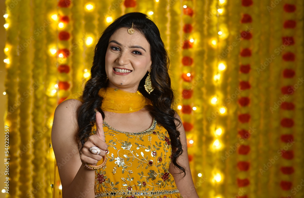 Happy young woman celebrating diwali 
