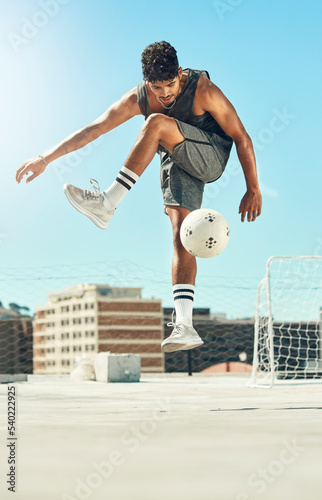 Fotografi Soccer, skill and man athlete training with a ball for a game or exercise on rooftop in the city