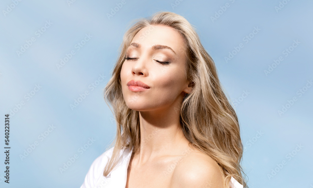 Beautiful blonde girl with shining clean skin with natural cosmetics closed her eyes and enjoys Beautiful blonde girl with shining clean skin with natural cosmetics closed her eyes and enjoys