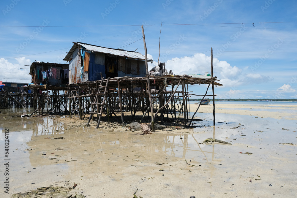 Omadal Island is a Malaysian island located in the Celebes Sea on the state of Sabah. The bajau laut village community during low tide time. Omadal Island is a Malaysian island located in the Celebes Sea on the state of Sabah. The bajau laut village community during low tide time.
