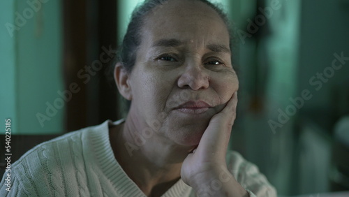 A hispanic senior woman portrait face looking at camera. A Brazilian person looking at camera