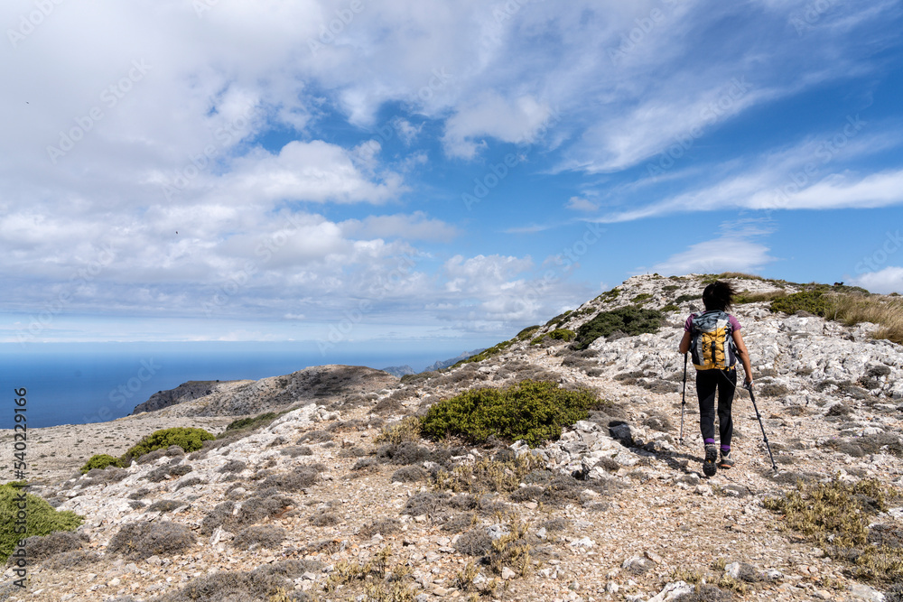 middle-aged woman walking along the path, Puig des Teix summit, 1064 meters,Valldemossa, Majorca, Balearic Islands, Spain