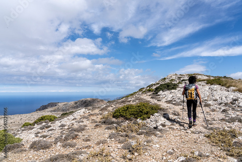 middle-aged woman walking along the path, Puig des Teix summit, 1064 meters,Valldemossa, Majorca, Balearic Islands, Spain