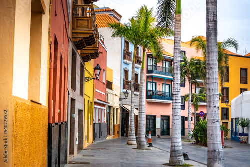 Fototapeta Naklejka Na Ścianę i Meble -  Tenerife. Colourful houses and palm trees on street in Puerto de la Cruz town, Tenerife, Canary Islands, Spain