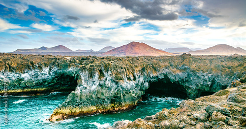 Amazing view of lava's caves Los Hervideros and volcanoes in Lanzarote island, popular touristic attraction. Location: Lanzarote, Canary Islands, Spain. Artistic picture. Beauty world.