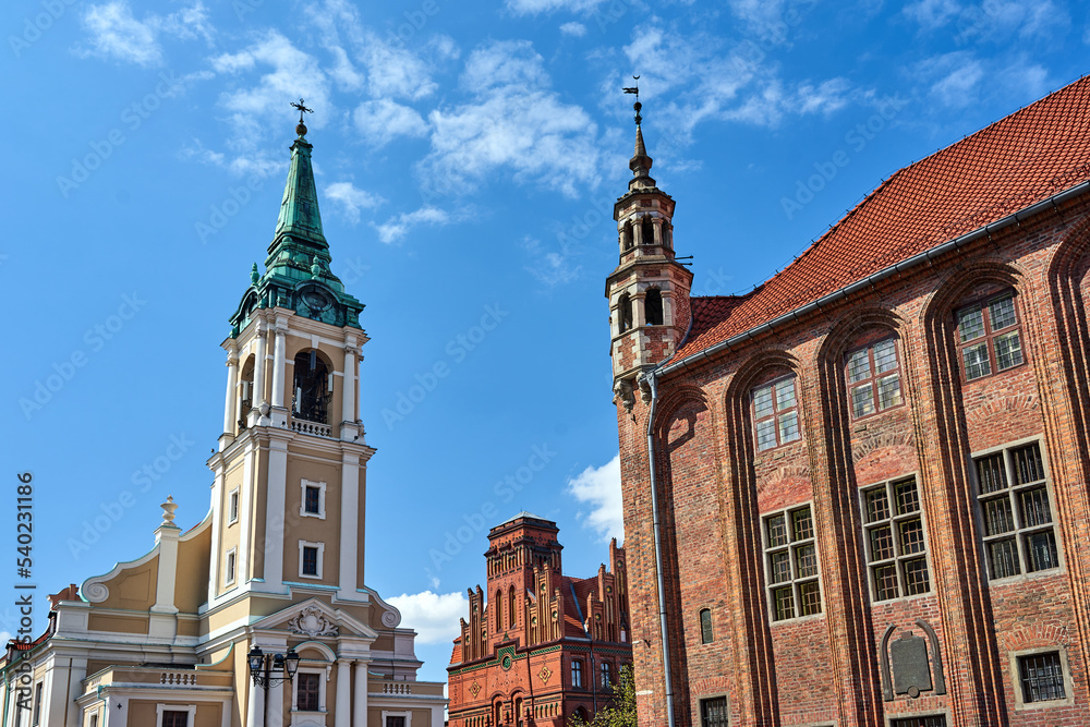 The belfry of a baroque church and the turret of the gothic town hall in Torun