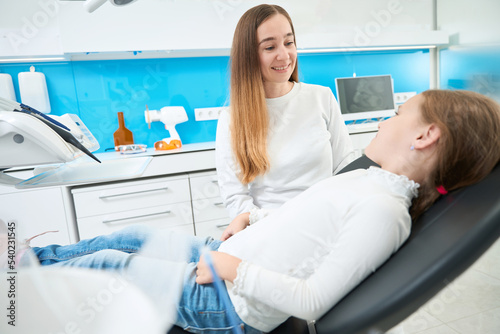 Pediatric dentist receiving little patient in her office