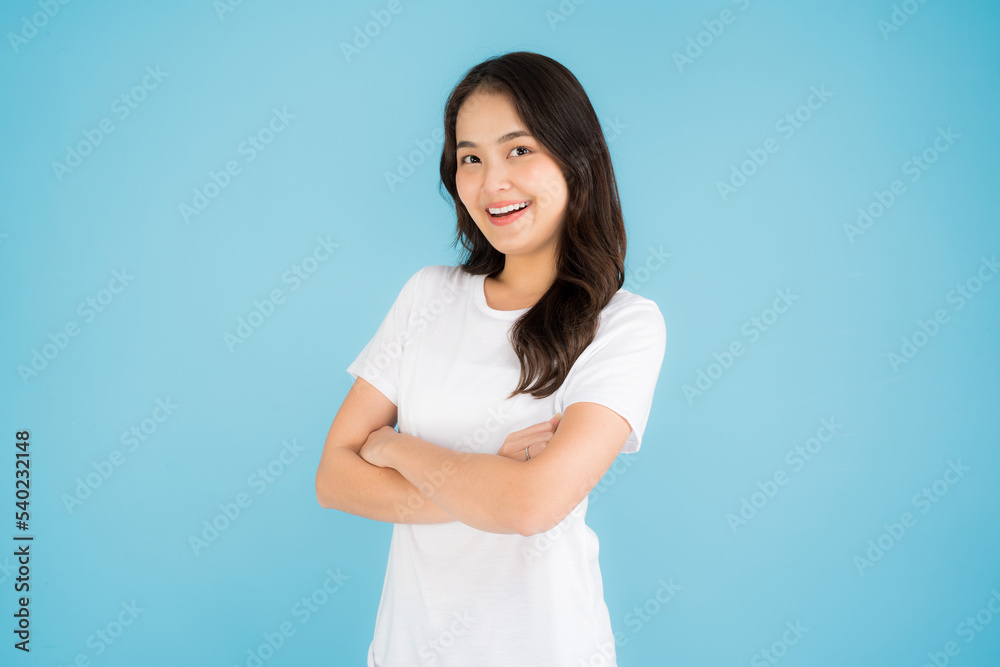 Beautiful Asian woman standing doing various poses on a blue background. Beautiful Asian woman standing doing various poses on a blue background.