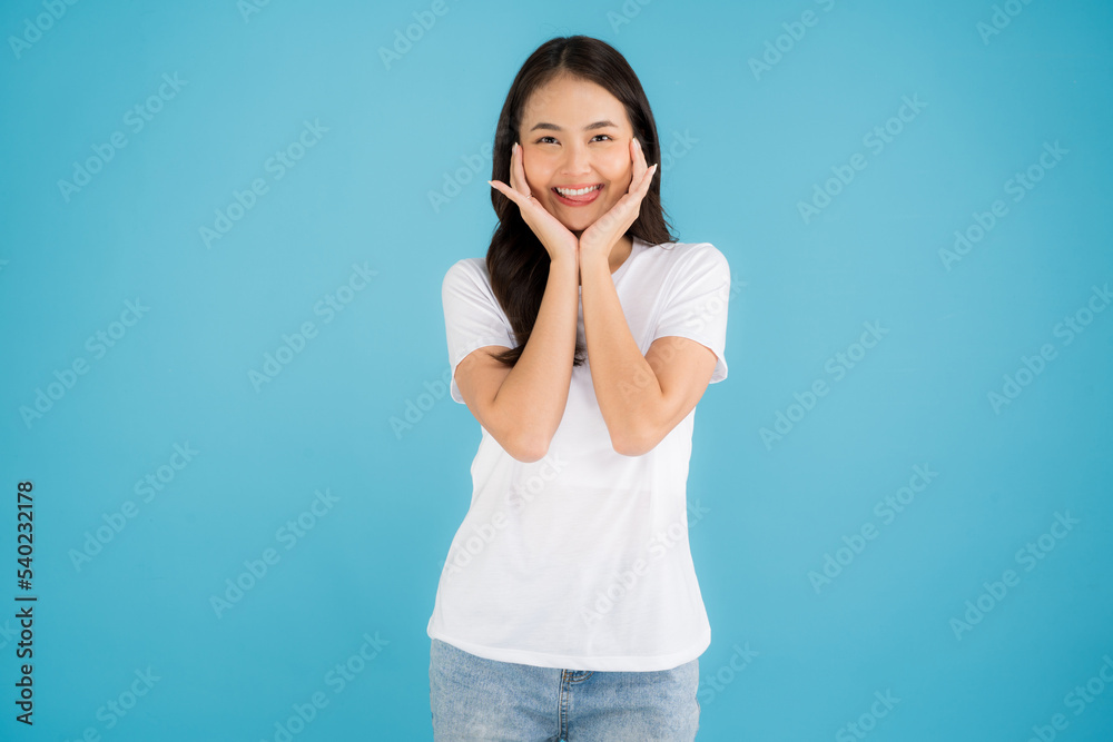 Beautiful Asian woman standing doing various poses on a blue background. Beautiful Asian woman standing doing various poses on a blue background.