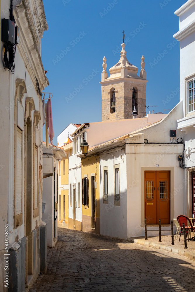 Portugal, August 2022: Street and bell tower at Loulé near Faro, Algarve, Portugal