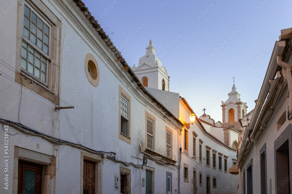 Portugal, August 2022: Street with white buildings at night, Lagos, Algarve, Portugal