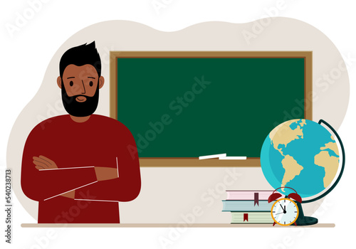 Male teacher near the blackboard. The concept of education, teaching, teacher's day.