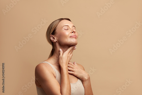 Fotografie, Obraz Smiling Woman Touching Neck