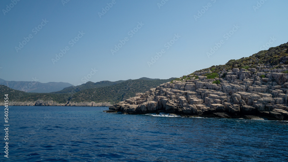Mountain of rocks in the foreground over the sea