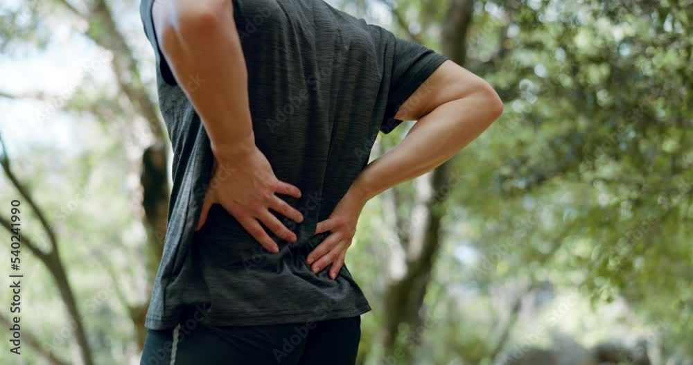 Running, fitness injury and man with back pain, emergency or muscle strain while doing exercise, training or cardio. Sports injury, athlete lifestyle and runner with hurt spine on nature park workout