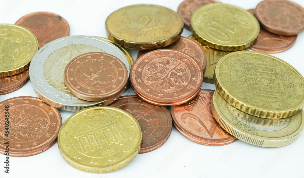 Scattering silver and gold coins, isolated on white background. A group of coins symbolize wealth, richness, income and profit. Scattering silver and gold coins, isolated on white background. A group of coins symbolize wealth, richness, income and profit.