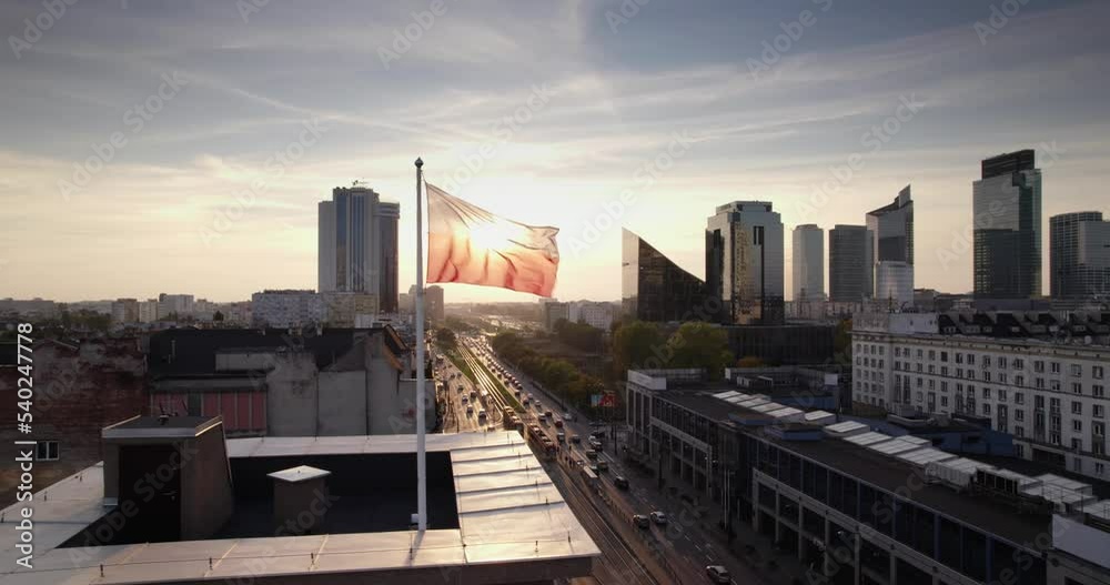 Poland flag waving slow motion with the beautiful clouds and Warsaw city center in the background. National Day Celebration, Independence Constitution Day
