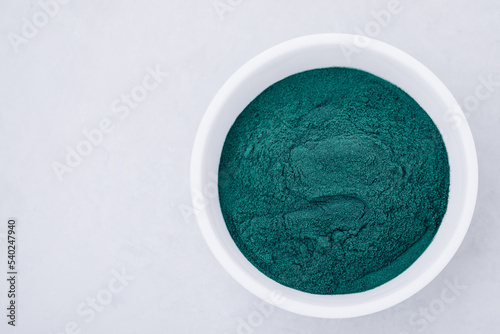 Spirulina. Green algae powder chlorella, spirulina in bowl on gray stone background