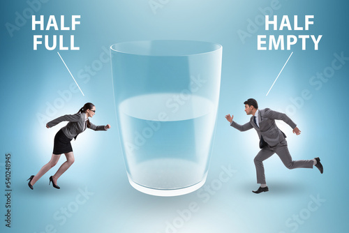 Фотография Businessman in half empty half full glass concept