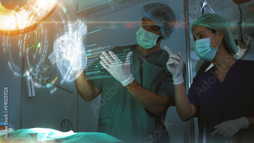 Futuristic simulation operating room - a surgeon diagnosing a senior woman's heart problem via a holographic heart scan simulation before surgical procedure. Concept hospital care photo