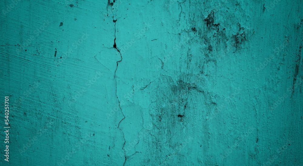 Obraz premium A textured background featuring a deep teal color with a distressed, grunge appearance. The surface shows variations in tone and subtle patterns, creating an abstract and moody aesthetic.