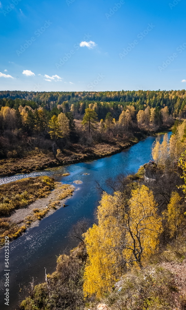Fototapeta premium Autumn landscape with river, trees, grass and blue sky