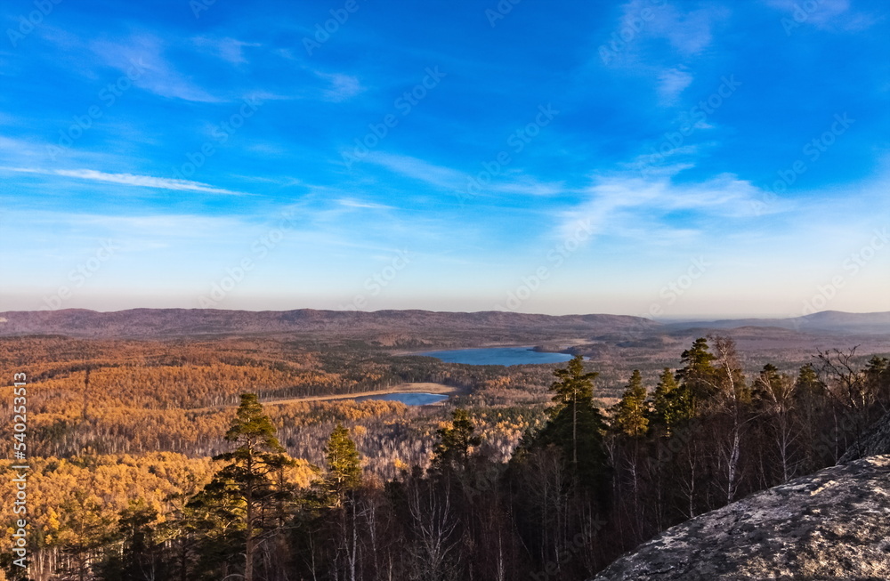 Autumn landscape from the top of a mountain with a lake, trees, mountains and sky Autumn landscape from the top of a mountain with a lake, trees, mountains and sky