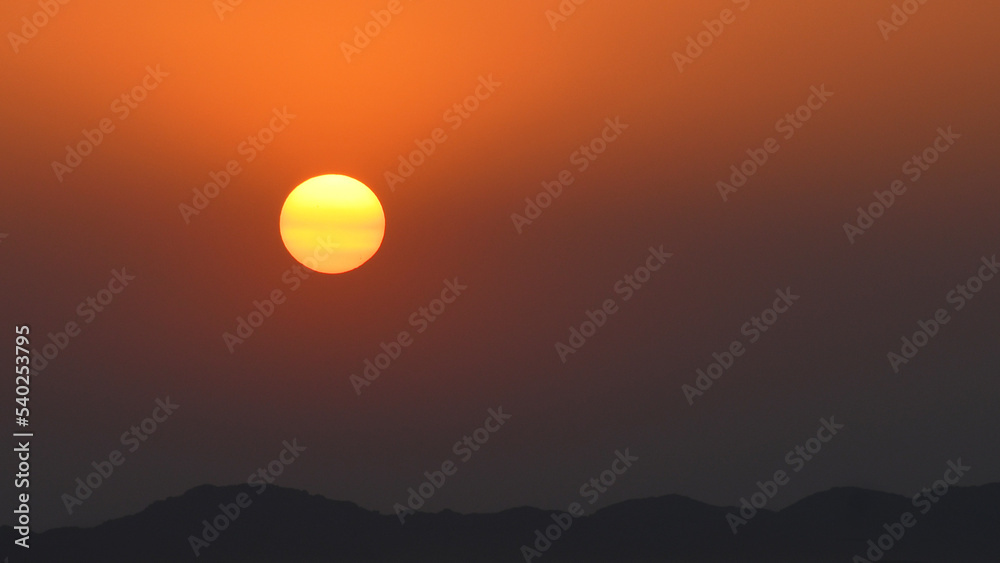 A yellow orange sunset at the desert. Al Medina Al Munawarah, Hail, Saudi Arabia.