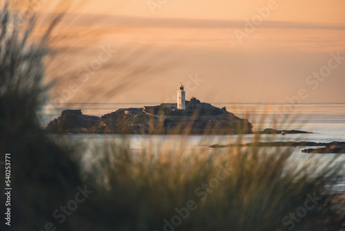 sunset over the godrevy lighthouse