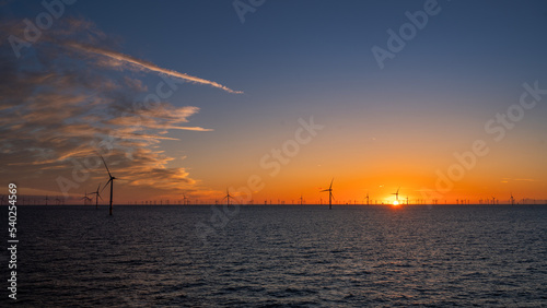 Beautiful night offshore with nice clouds around. Wind park. © Alex