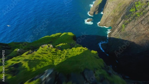 Aerial Tilt Up Shot Of Natural Rock Formations In Sea, Drone Descending On Sunny Day - Faroe Islands, Denmark