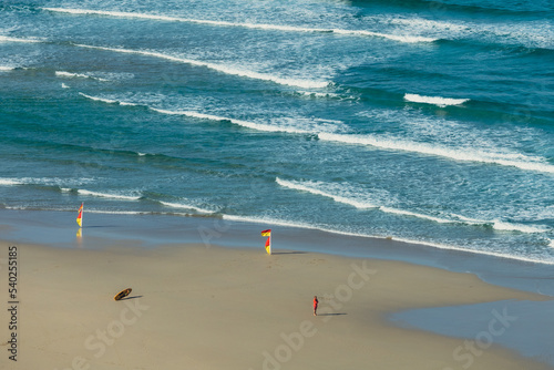 lifeguard standing on an empty beach photo