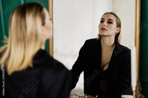 Woman looking at herself in a mirror