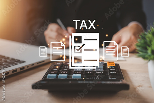 Individual income tax paid and corporations concept. Businessman using a calculator and laptop (notebook) of Data analysis, Paperwork, financial research, and report. photo