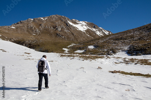 Hiker on the summit of a mountain with snow © ciroorabona