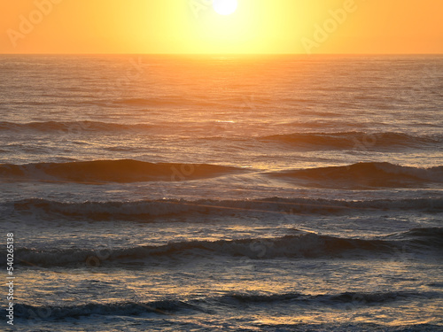 The sun rises just above the horizon over the Atlantic Ocean.