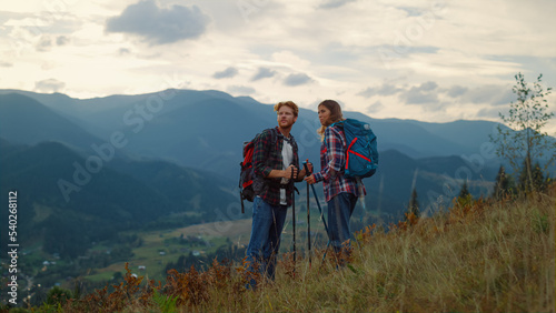 Canvas Print Young family hiking together on mountains nature sunset