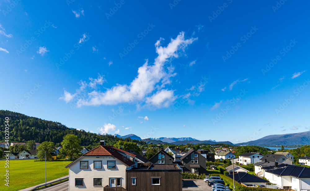Wooden Buildings With Scandinavian Mountain Range View In Port Town Alesund, Sunnmore District, West Coast Of Norway
