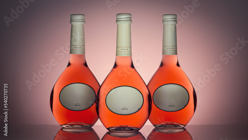 Bottles with rose wine on a pink background. Isolated bottles of wine, front view. Mock up for labels
