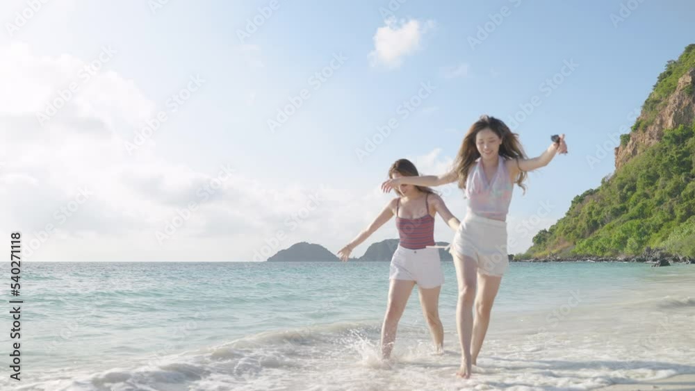 Two Asian female bloggers are taking pictures with action cam to show off to their friends on social media during a beach trip on an island in the sea, concept of freedom, travel, adventure
Two Asian female bloggers are taking pictures with action cam to show off to their friends on social media during a beach trip on an island in the sea, concept of freedom, travel, adventure