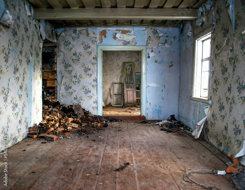 Inside an abandoned farmhouse. Wooden cottage in small abandoned village. Grunge background. © KATSIARYNA