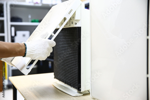 Wallpaper Mural Air conditioner repairman open cover to fix and holding dirty and dusty air filter for removing and change to a new one. Concept of heat and clean or maintenance service repair and install. Torontodigital.ca