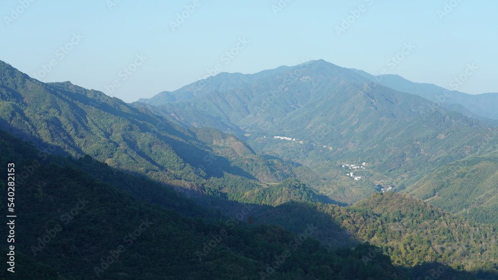 The beautiful traditional Chinese village view with the classical architecture and fresh green trees as background