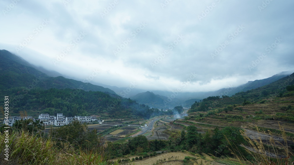 The beautiful traditional Chinese village view with the classical architecture and fresh green trees as background