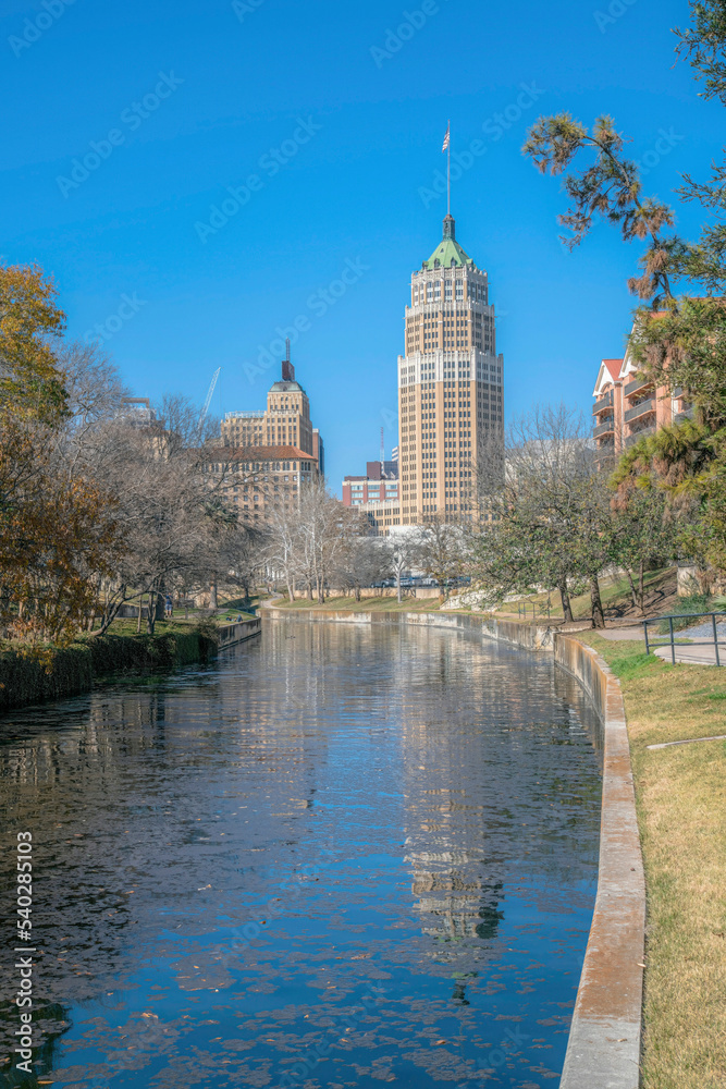View of San Antonio River and a tall tower at San Antonio, Texas River Walk