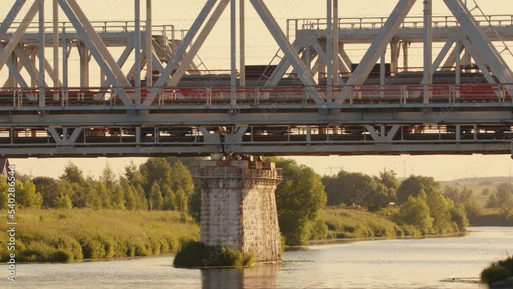 Freight train rides on railway bridge. Delivery, logistics, transportation of goods by rail. Freight train rides on railway bridge. Delivery, logistics, transportation of goods by rail.
